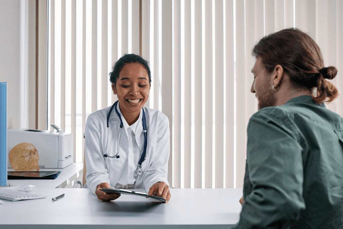 A doctor showing a patient a file 